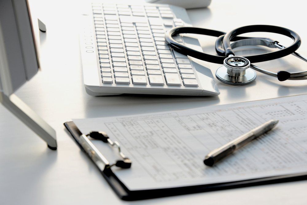 Desk with medical equipment, including stethoscope, clipboard, keyboard, and pen. — Mid North Coast Sleep Clinic in Taree, NSW