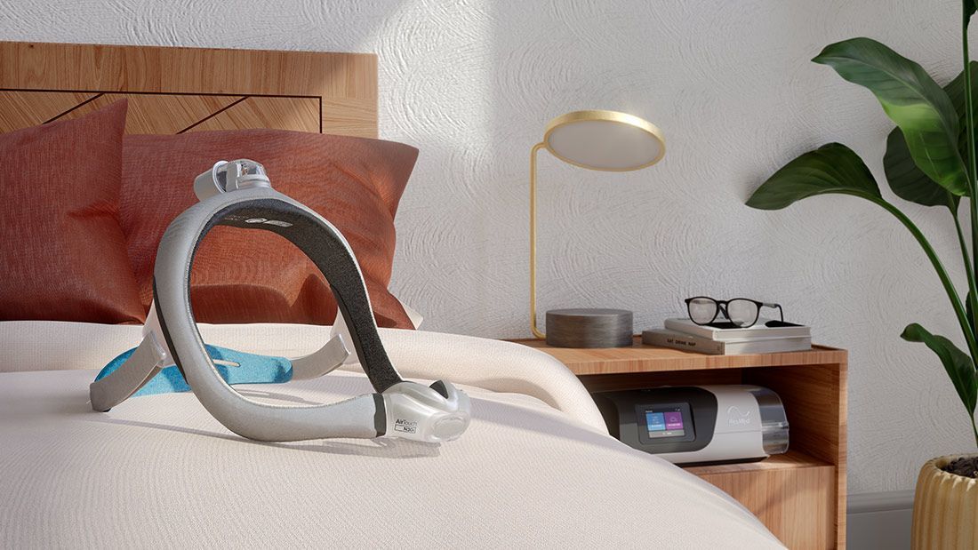 A CPAP Machine is Sitting on Top of a Bed in a Bedroom — Mid North Coast Sleep Clinic in Taree, NSW
