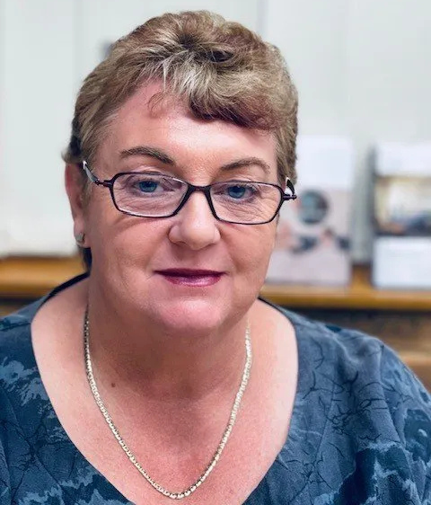 Woman with glasses, short hair, and a necklace, looking at the camera. — Mid North Coast Sleep Clinic in Taree, NSW