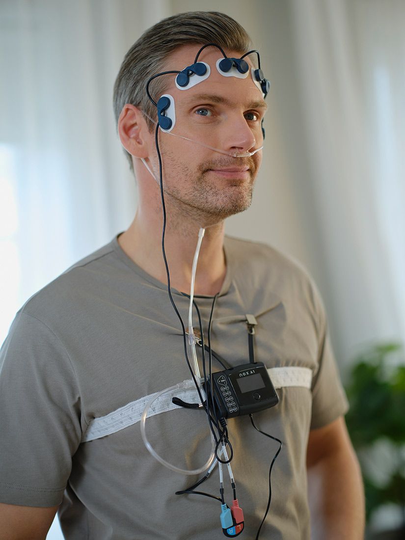 A man is wearing a device on his head. — Mid North Coast Sleep Clinic in Taree, NSW