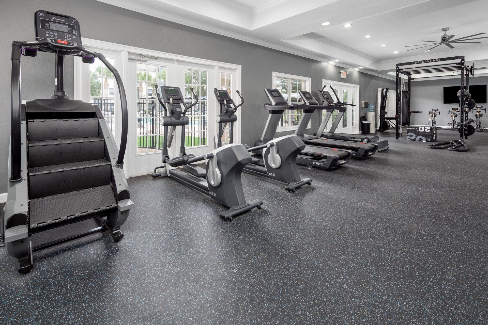 A gym with a lot of treadmills and exercise bikes.