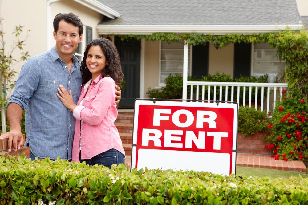 Hispanic couple outside a home for rent