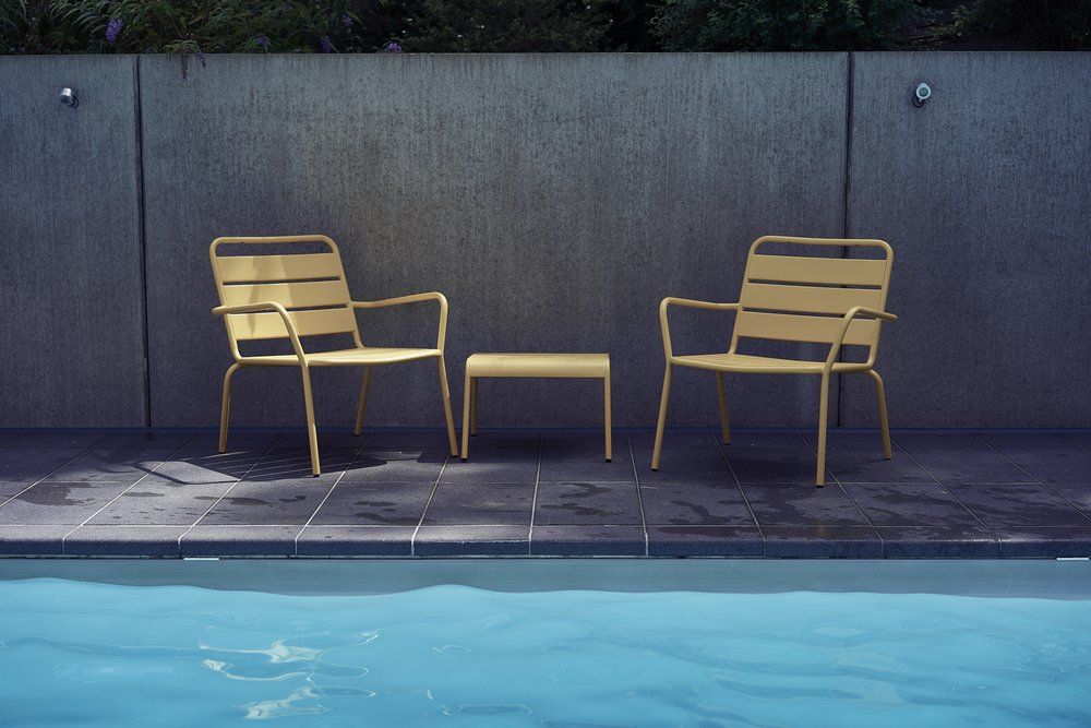 Yellow chairs by a pool