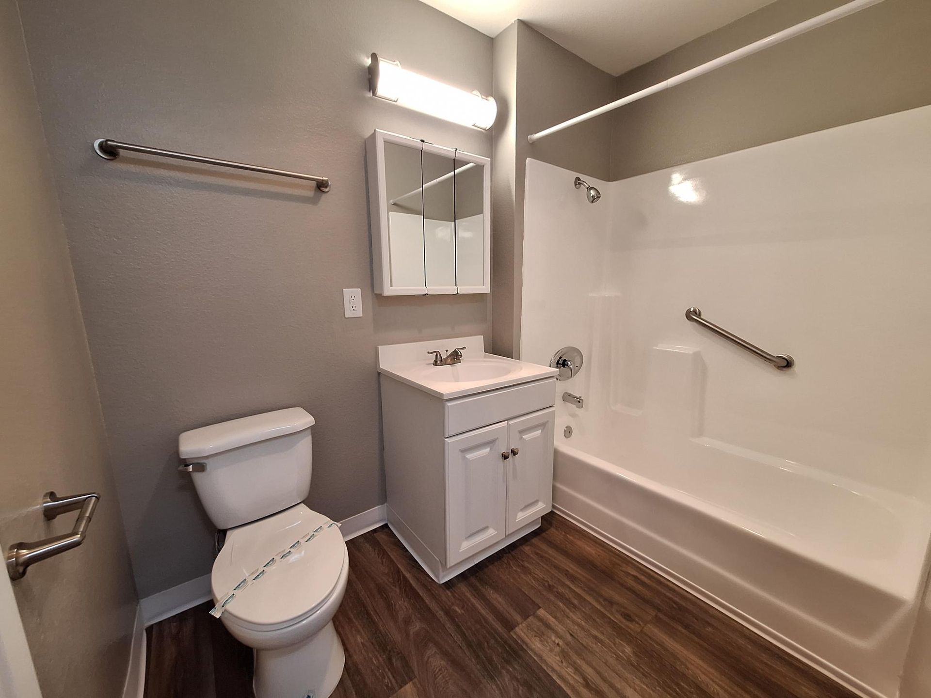 A bathroom with a toilet , sink , and bathtub.