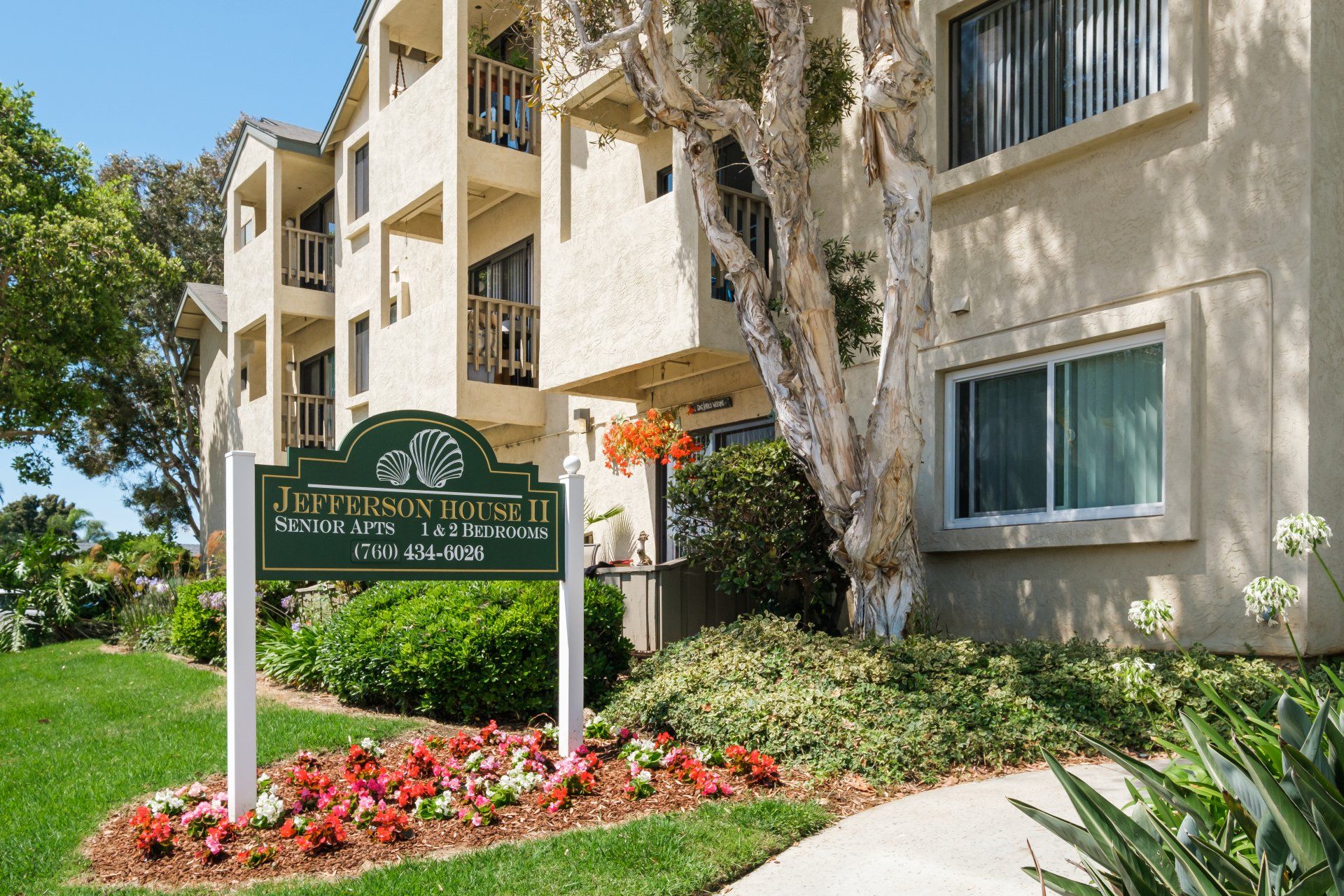 A large apartment building with a sign in front of it