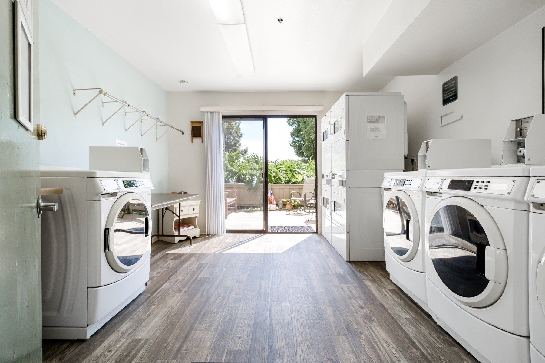 A laundry room with a washer and dryer and a sliding glass door.