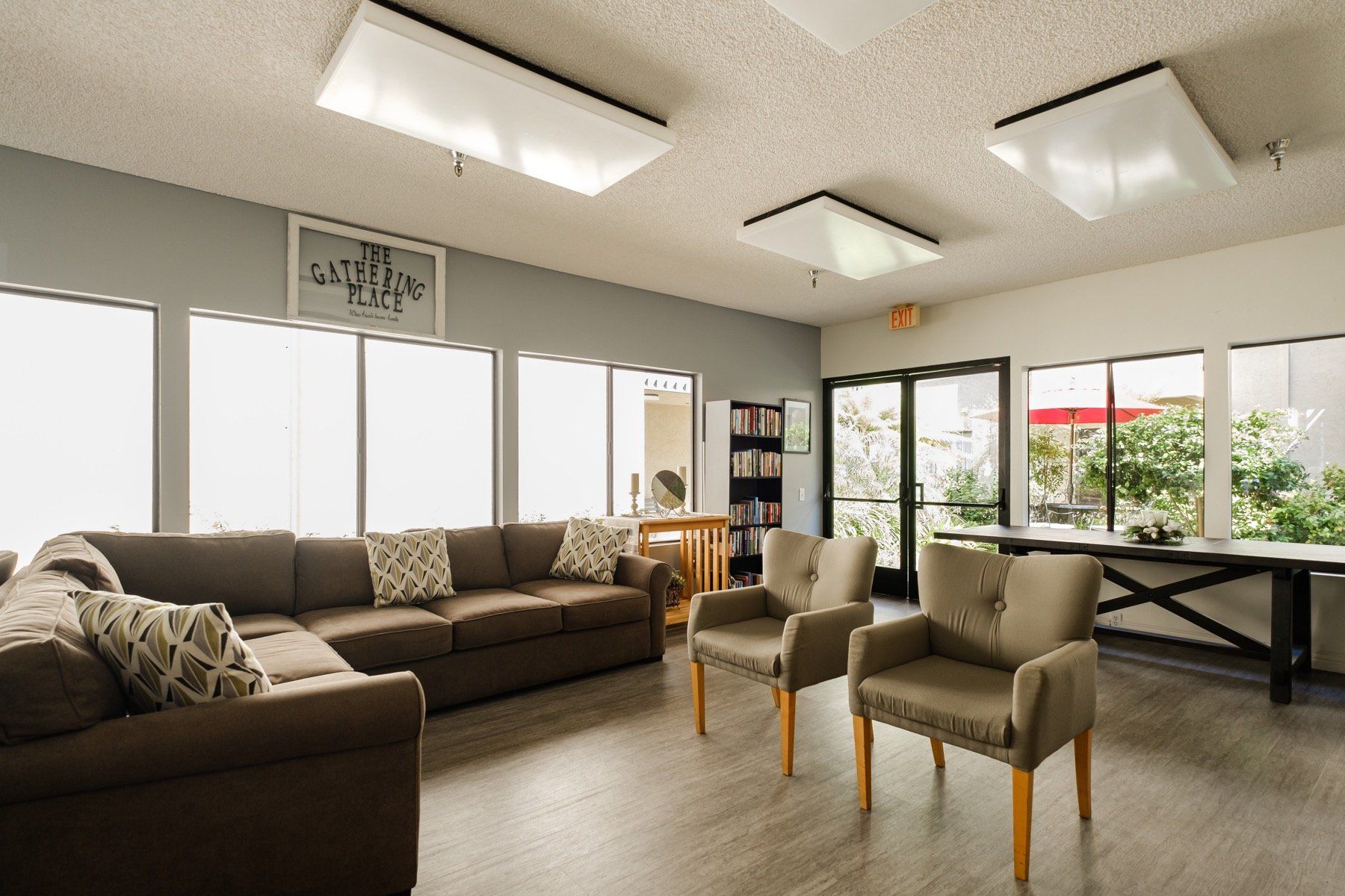 A living room with a couch , chairs , and a table.