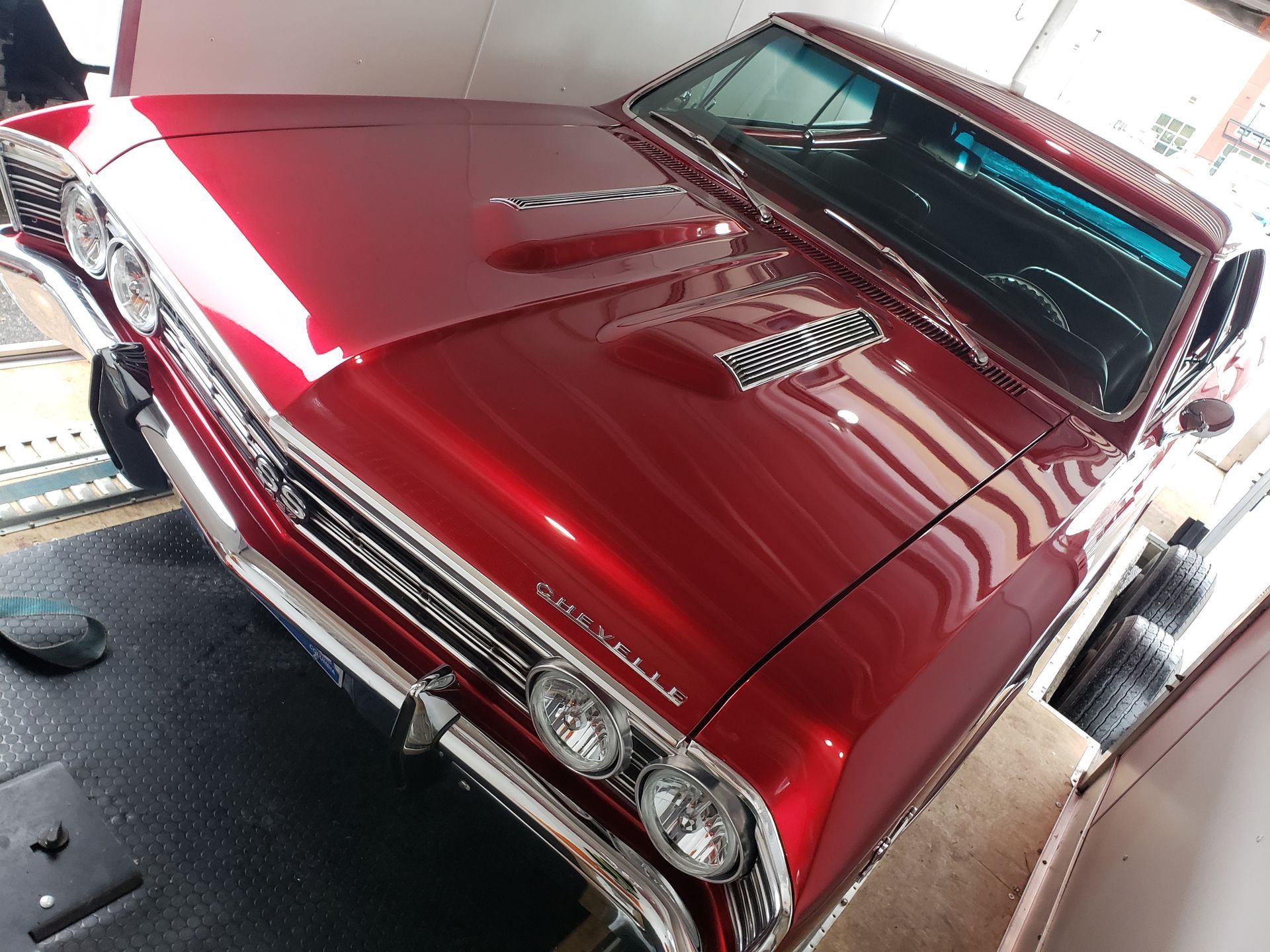 A red car with the word muscle on the front