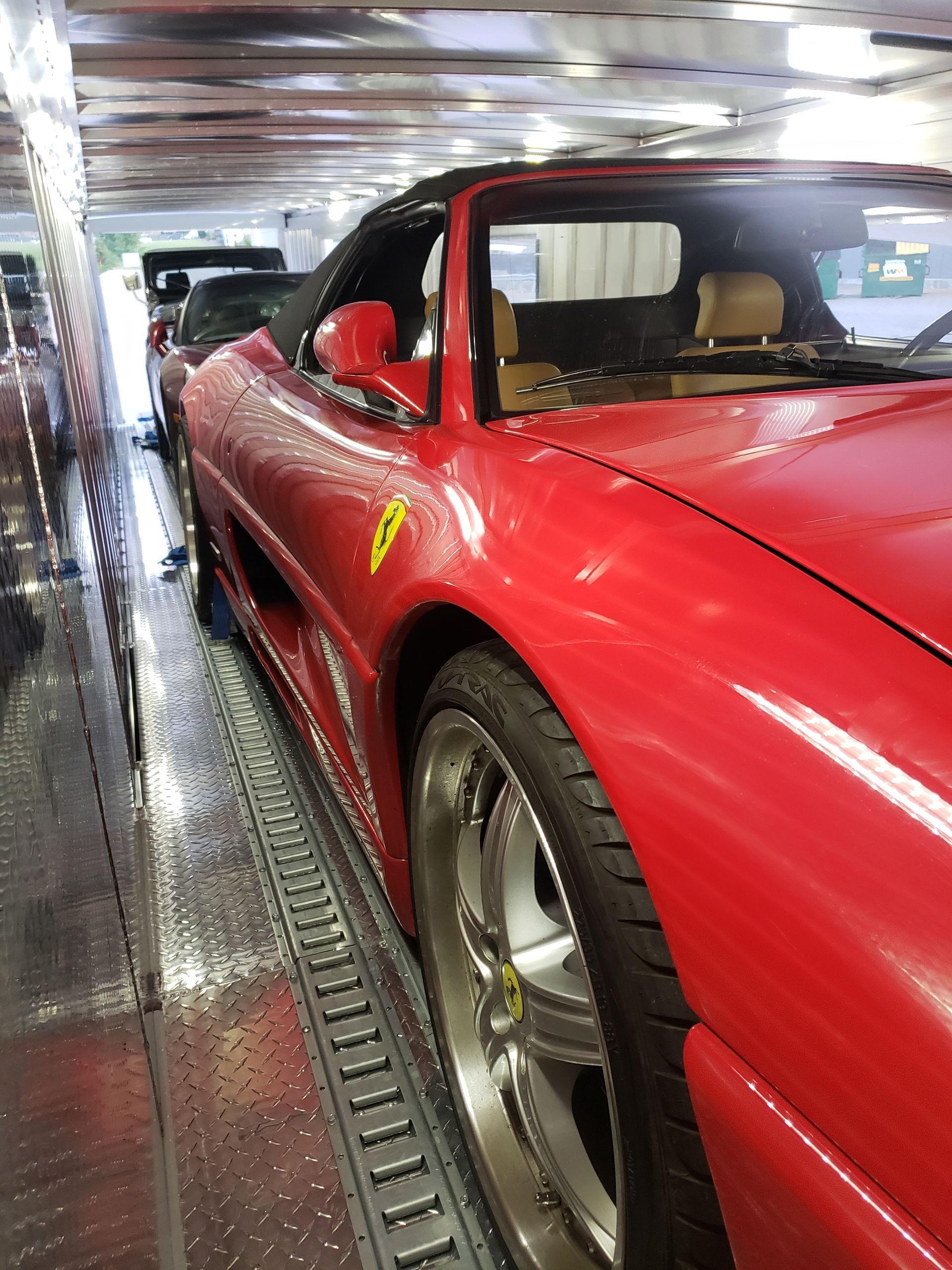 A red sports car with the letter v on the side