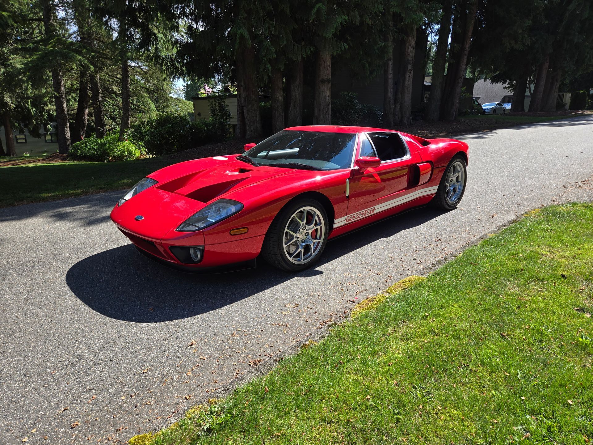 A red sports car is parked on the side of the road