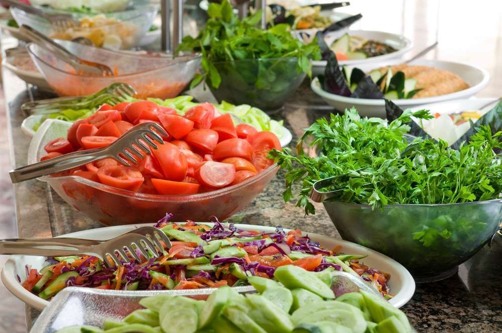 A table topped with bowls of vegetables and salads.