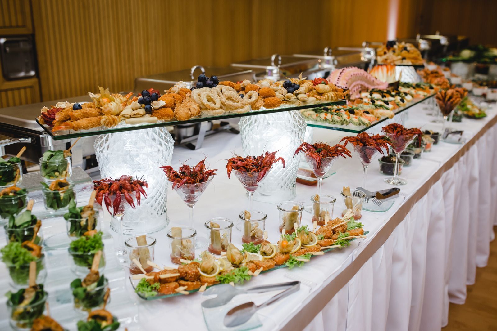 A long buffet table filled with lots of food and drinks.
