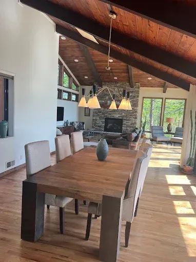 There is a dining table and chairs in the middle of the room.