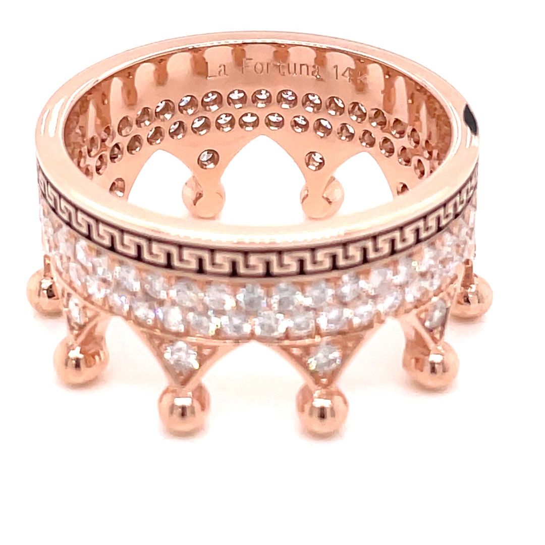 A rose gold ring with greek key design and diamonds