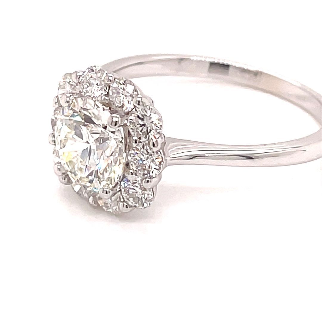 A close up of a diamond ring on a white background.