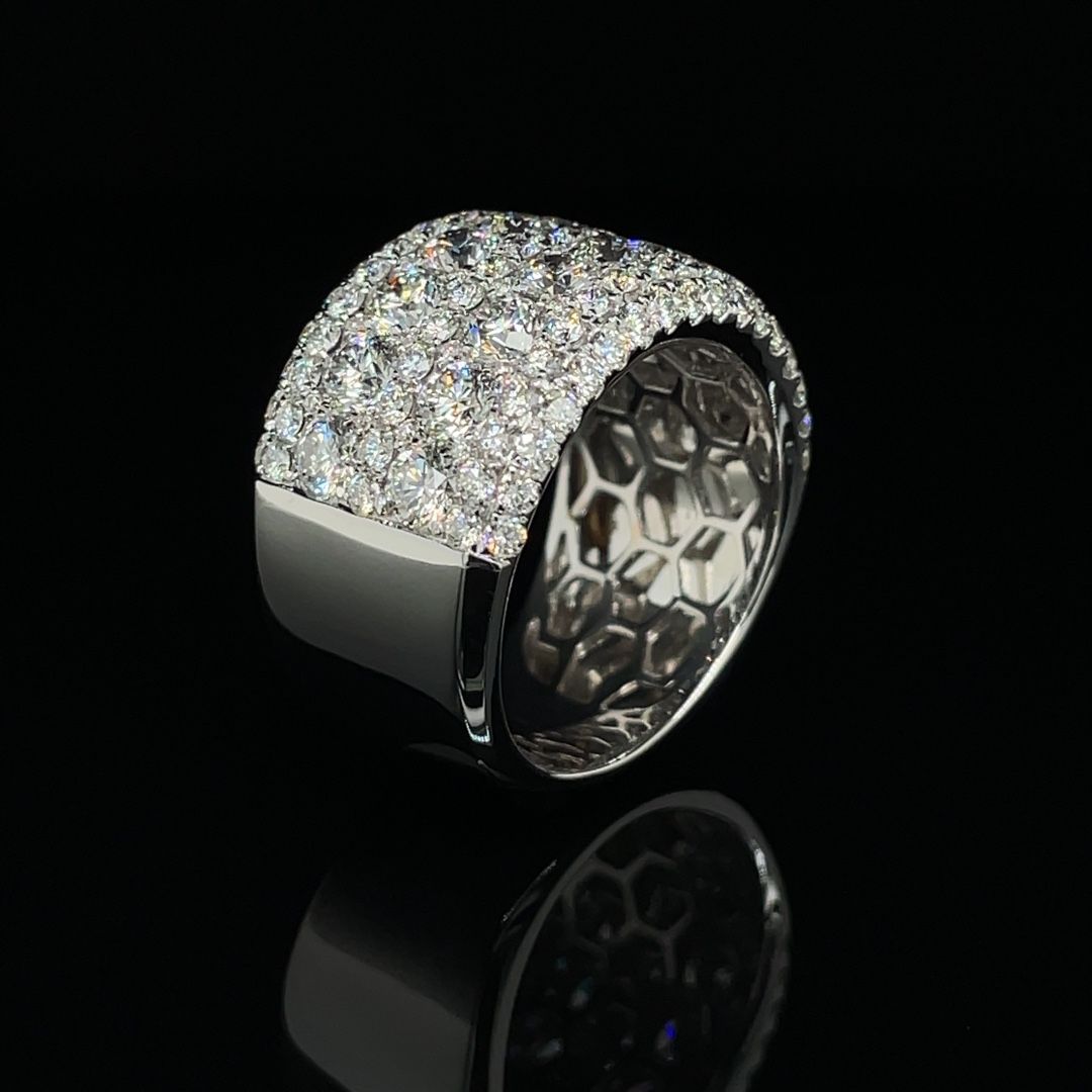 A white gold ring with diamonds on a black background