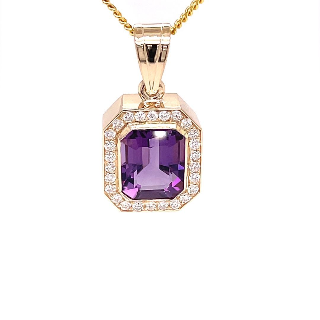 A gold pendant with a purple stone and diamonds on a chain.