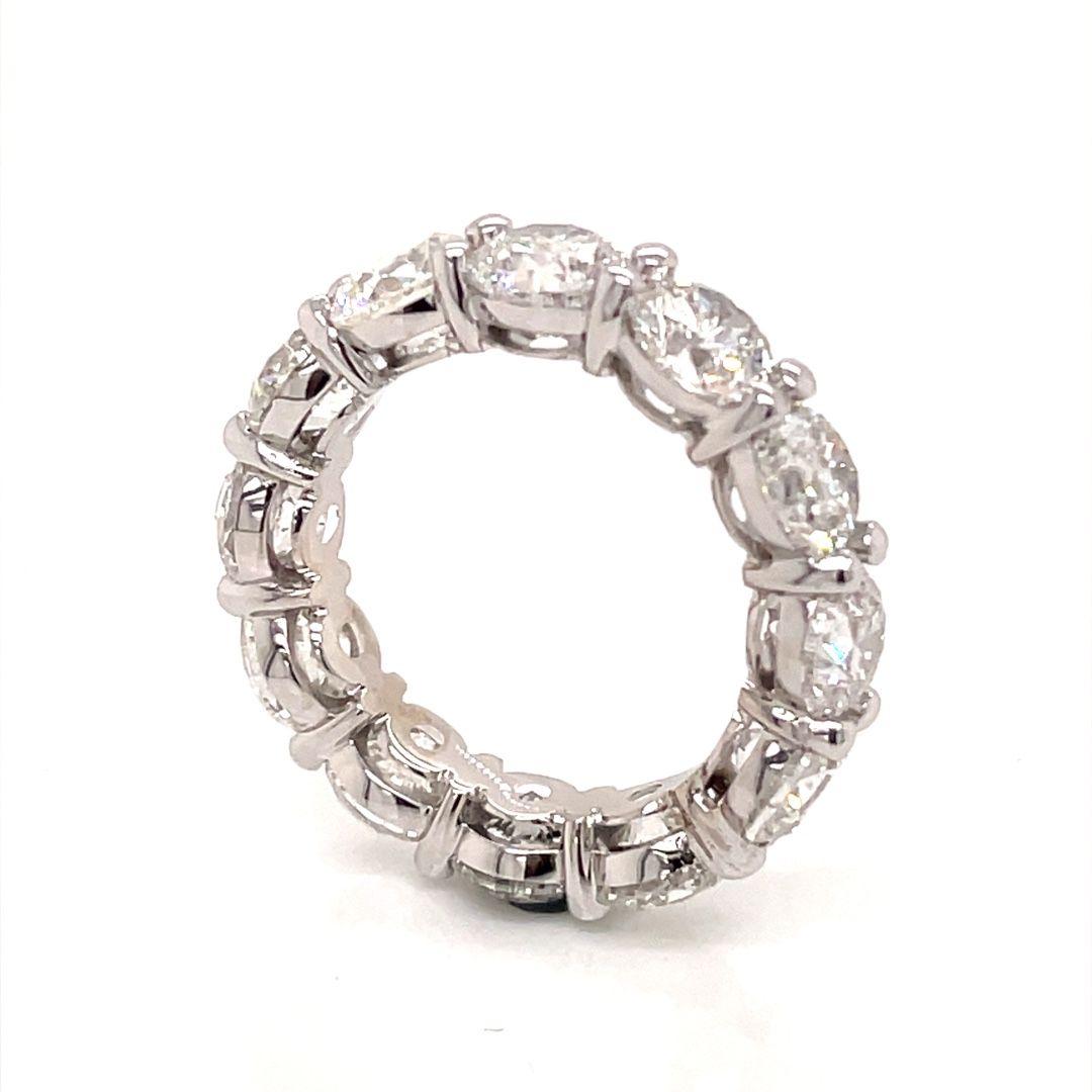 A white gold eternity ring with diamonds on a white background