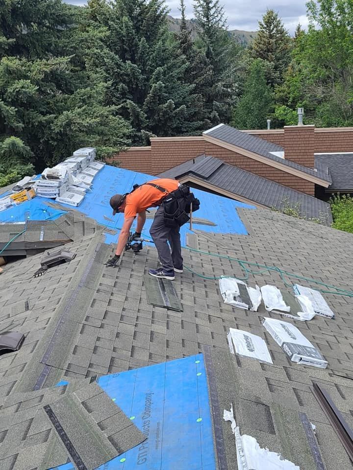 A man is working on the roof of a house.