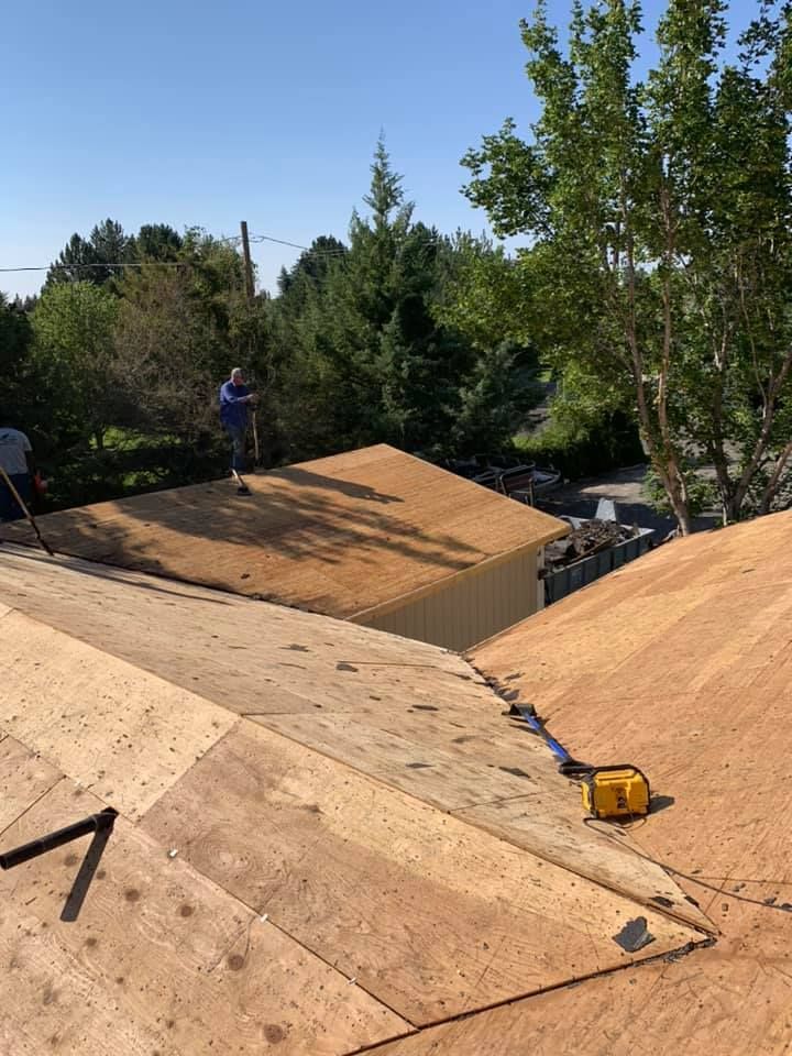A man is working on the roof of a house.