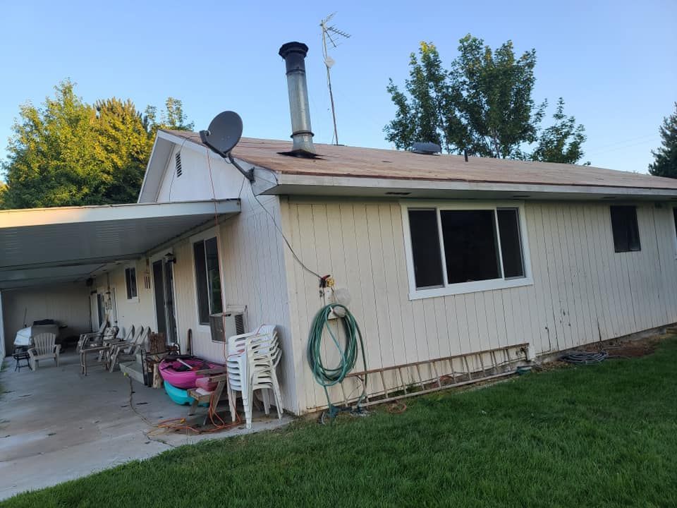 A white house with a satellite dish on the roof