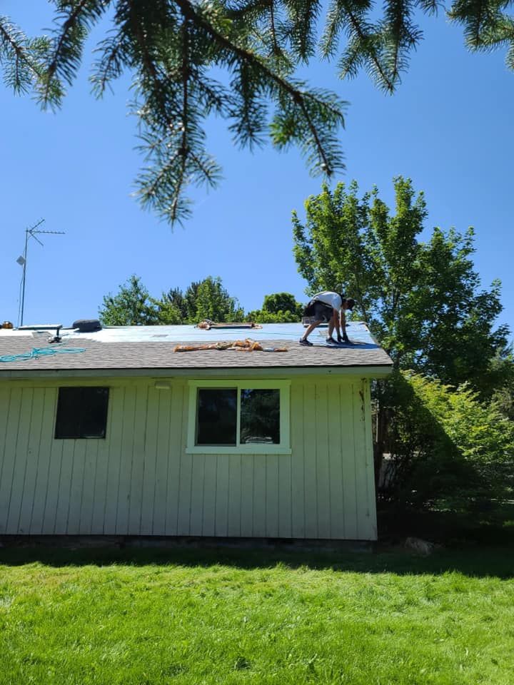 A man is working on the roof of a house