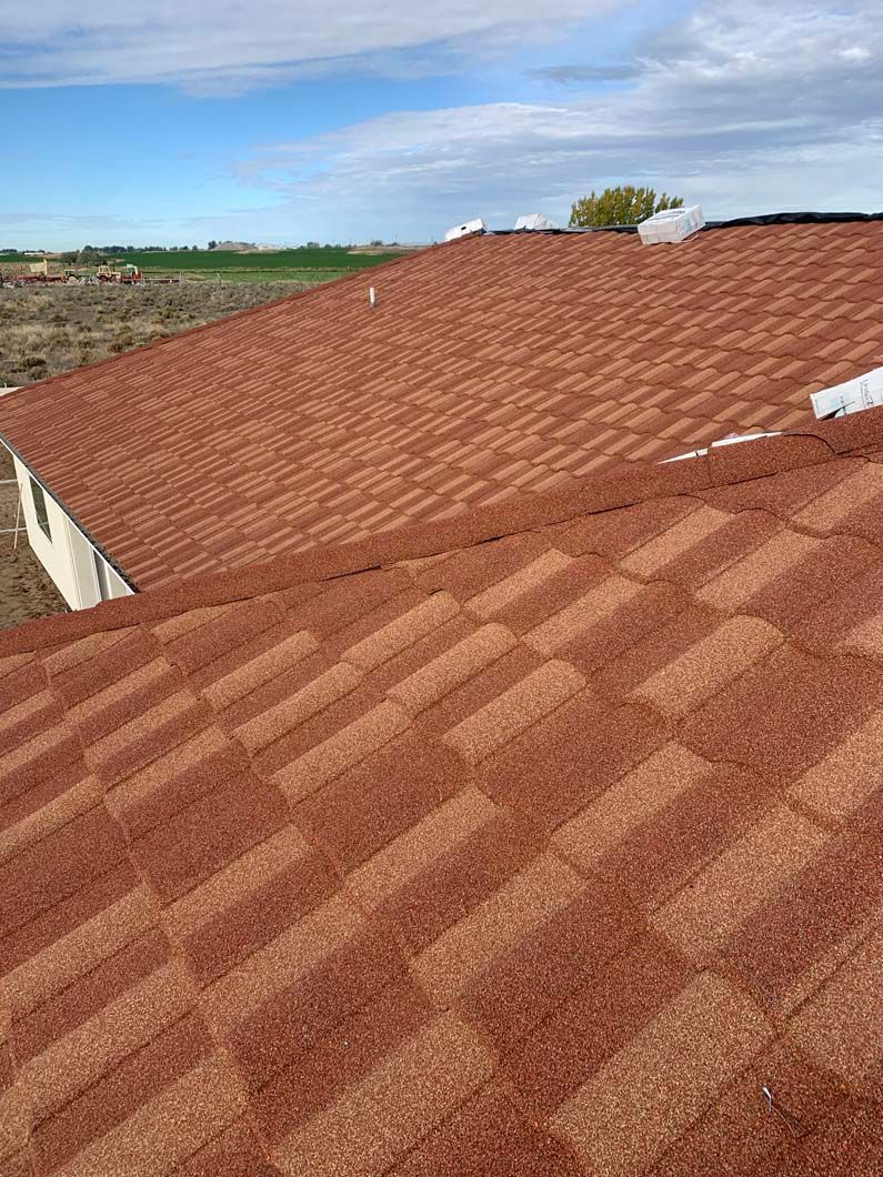 A close up of a red tile roof on a house.