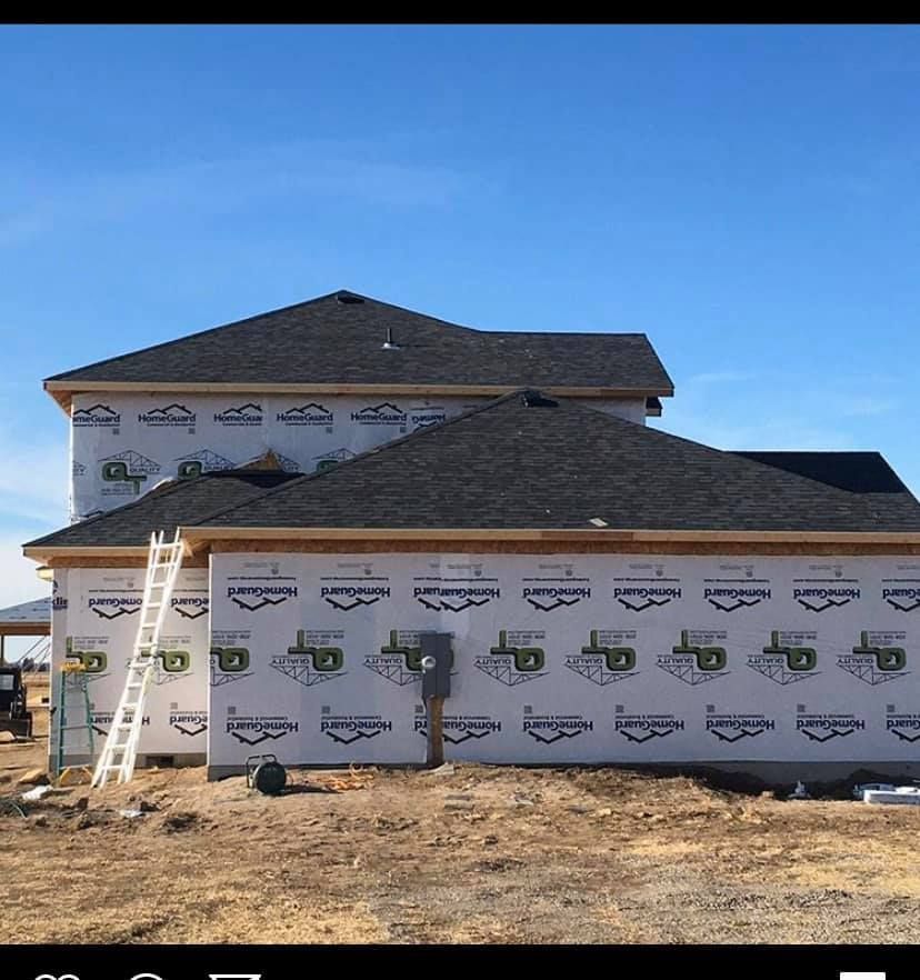 A house under construction with a ladder on the side