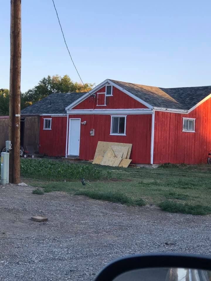 A red house with a white door and windows