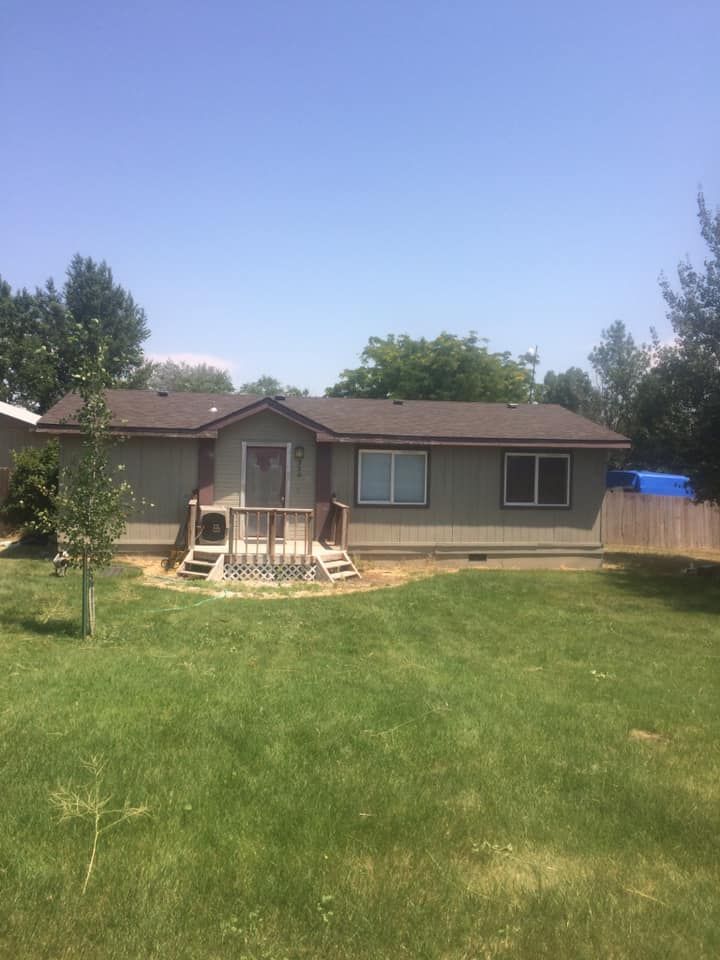 A house with a large lawn in front of it.
