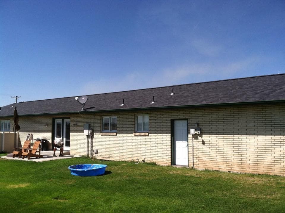 A house with a blue pool in the backyard