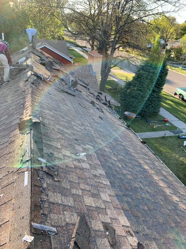 A man is working on the roof of a house.