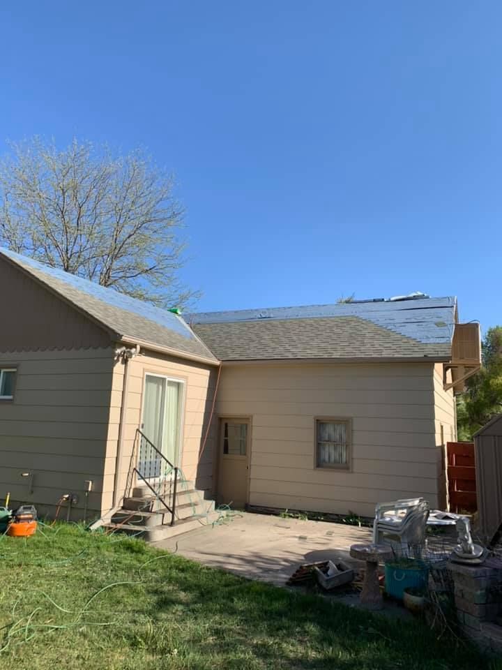 The back of a house with a roof that is being installed.