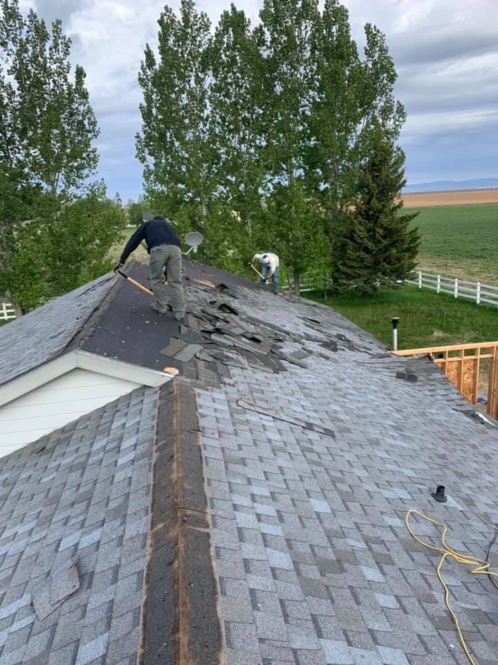 A man is working on the roof of a house.