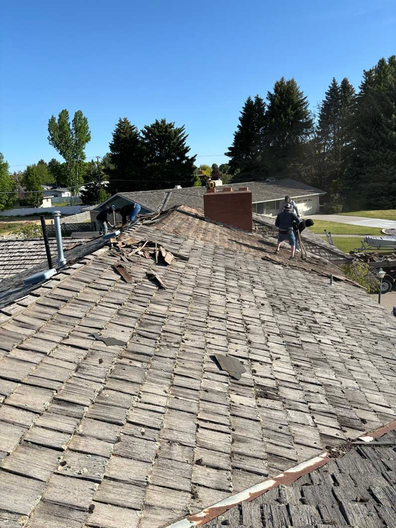 A man is working on the roof of a house.