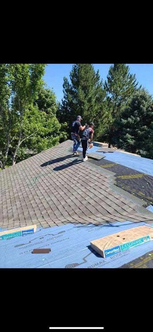 A group of people are working on a roof.