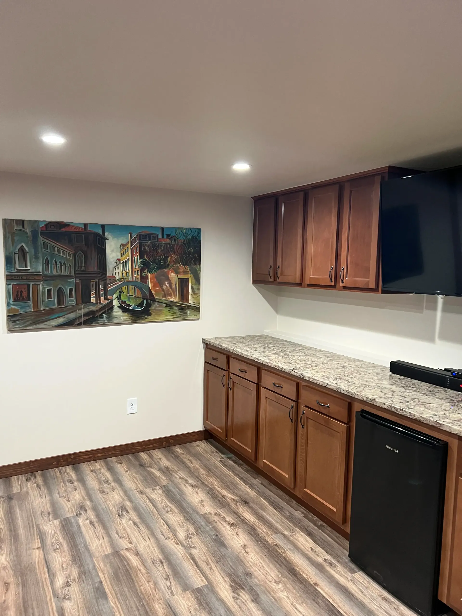An unfinished garage interior with bare, joint-compounded drywall walls and a concrete floor.