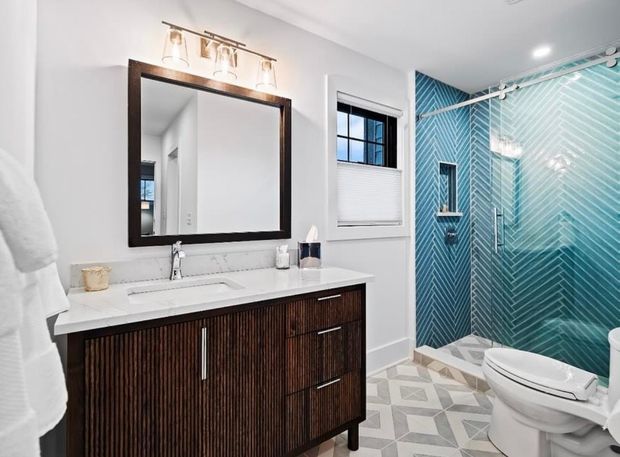 A white interior door set in a wall with unfinished drywall seams, situated in a basement room with a textured ceiling.