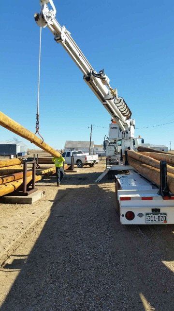 Offloading Truck Carrying Pole — Pueblo, CO —  Main Electric
