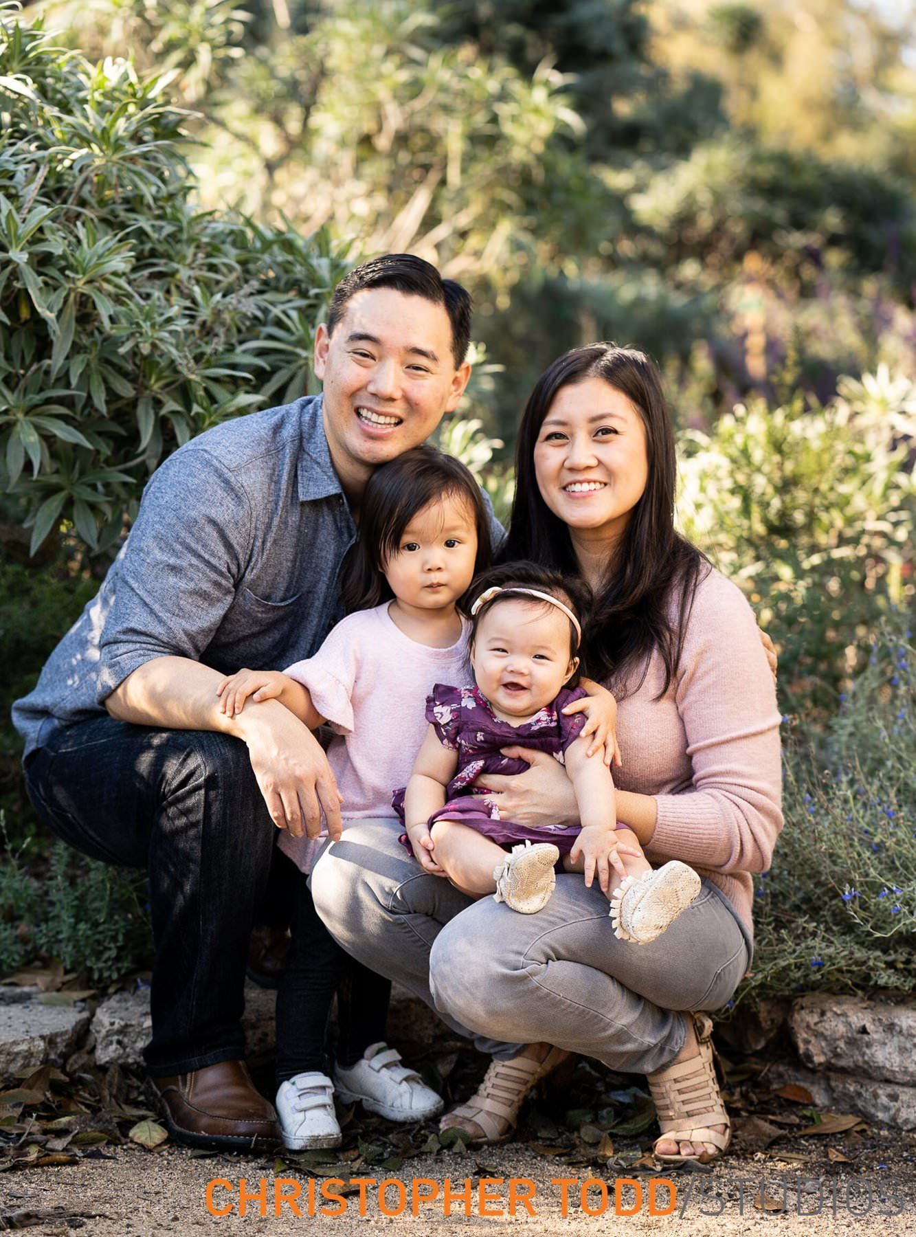 Huntington Central Park Family Session A young family is posing for a picture together in a park.
