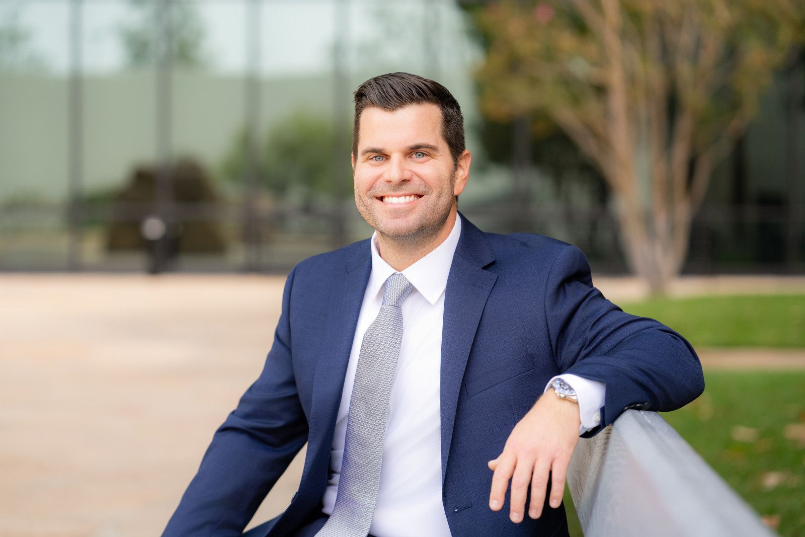 Man in black holding yellow and black braided ropes on his shoulders for a workout