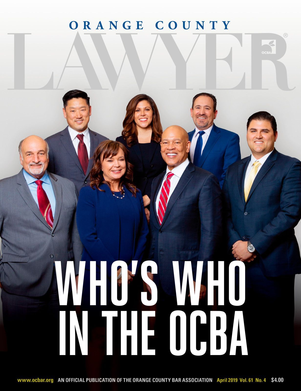 Group of seven professionals in business attire posing for the cover of Orange County Lawyer magazine.