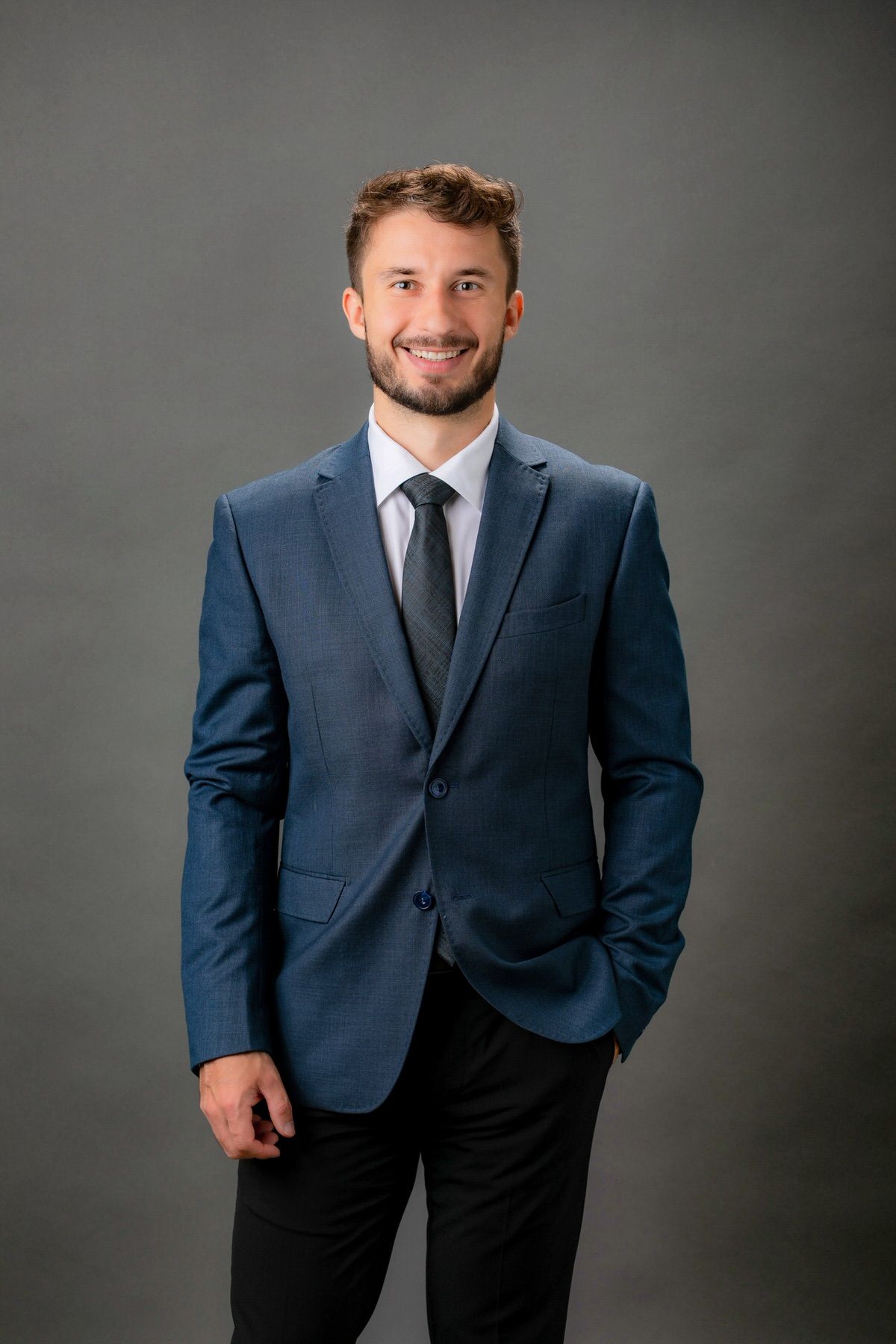 A business Headshot of a man in a studio