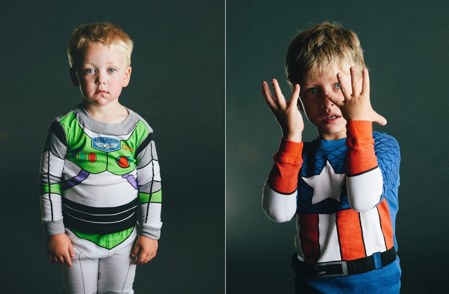 Two young boys dressed as buzz lightyear and captain america Pajamas, are standing next to each other.