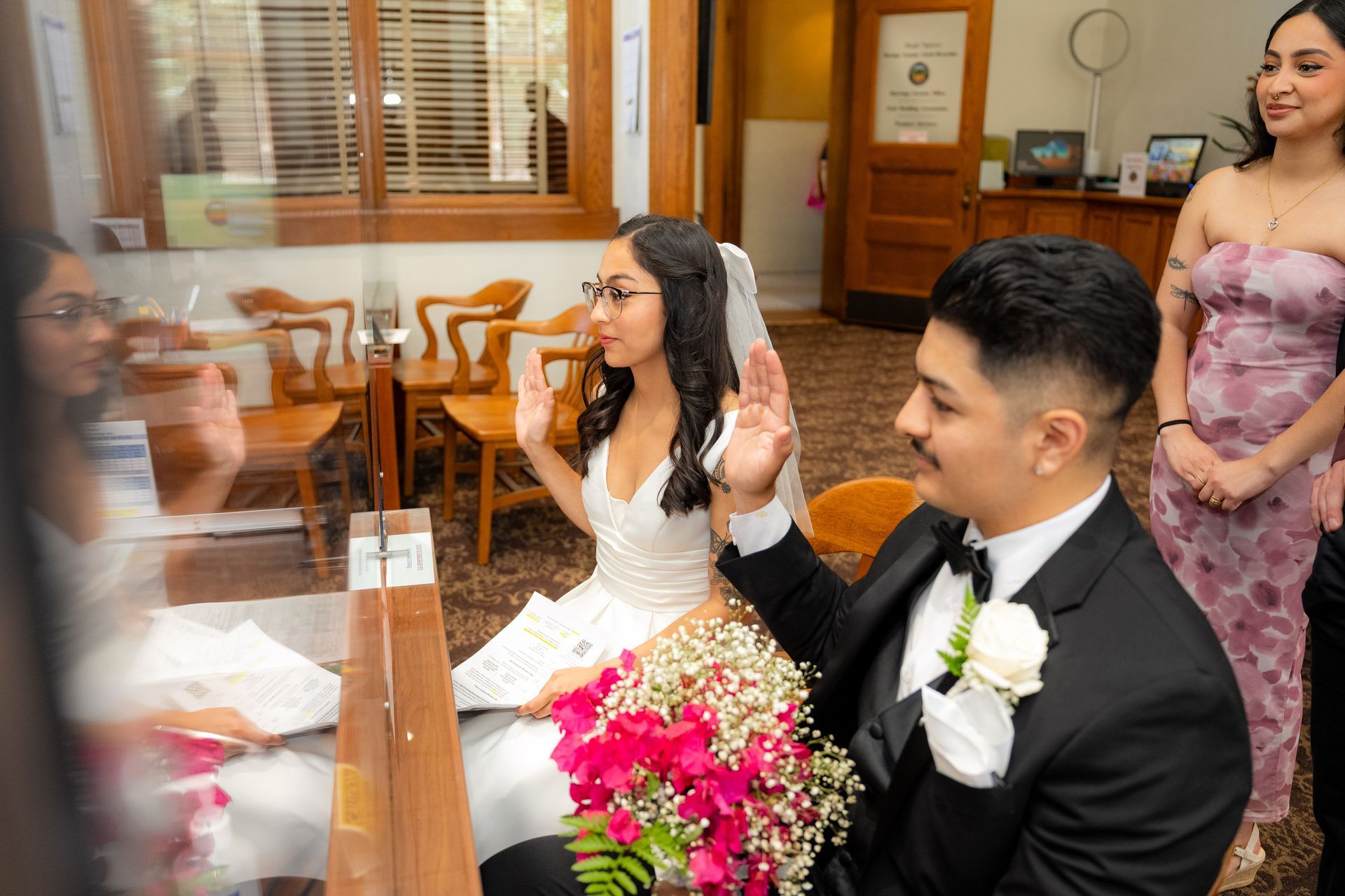 Couple signing Orange County marriage license at courthouse