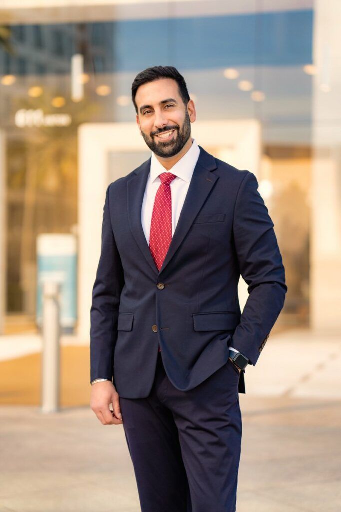 A man in a suit and tie is standing in front of a building.