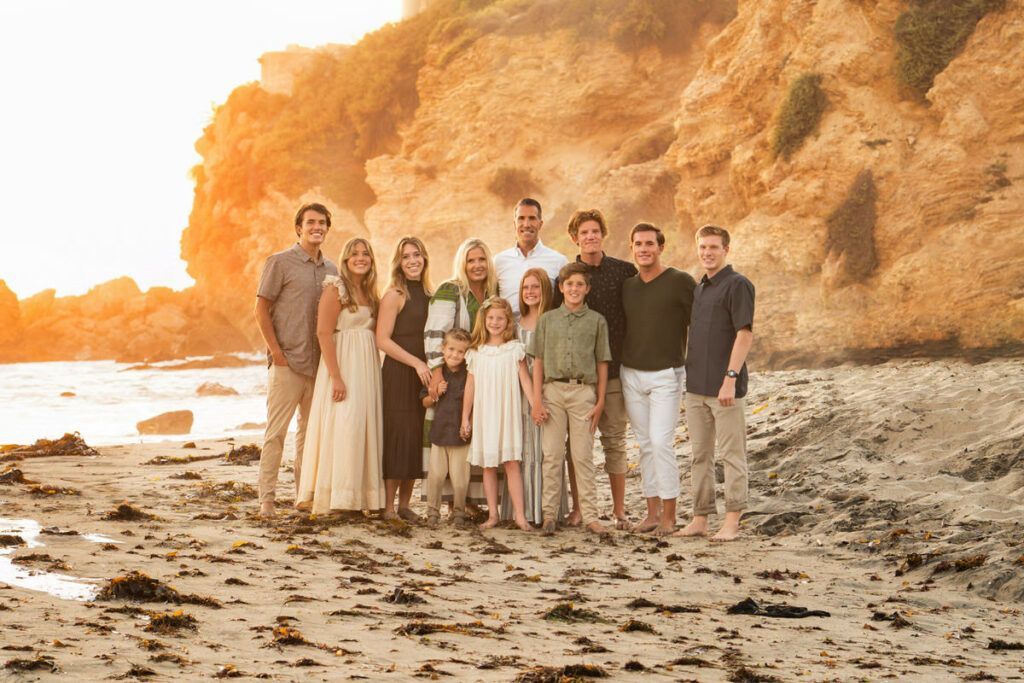 Orange County Beach Family Portrait A large family is posing for a picture on the beach.