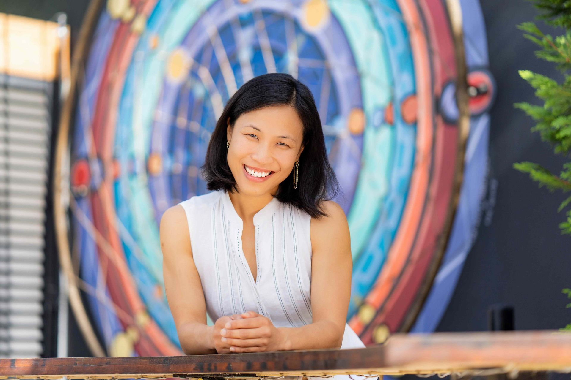 Dana Point Branding Photographer A woman is standing in front of a mural on a wall.