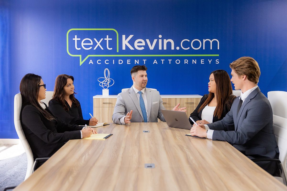 Dana Point Attorney Photographer A group of lawyers are sitting around a conference table.