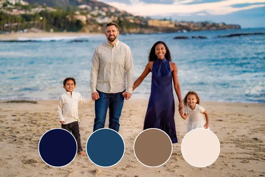 Beach Family Outfit Ideas for Photos A family is standing on a beach holding hands.